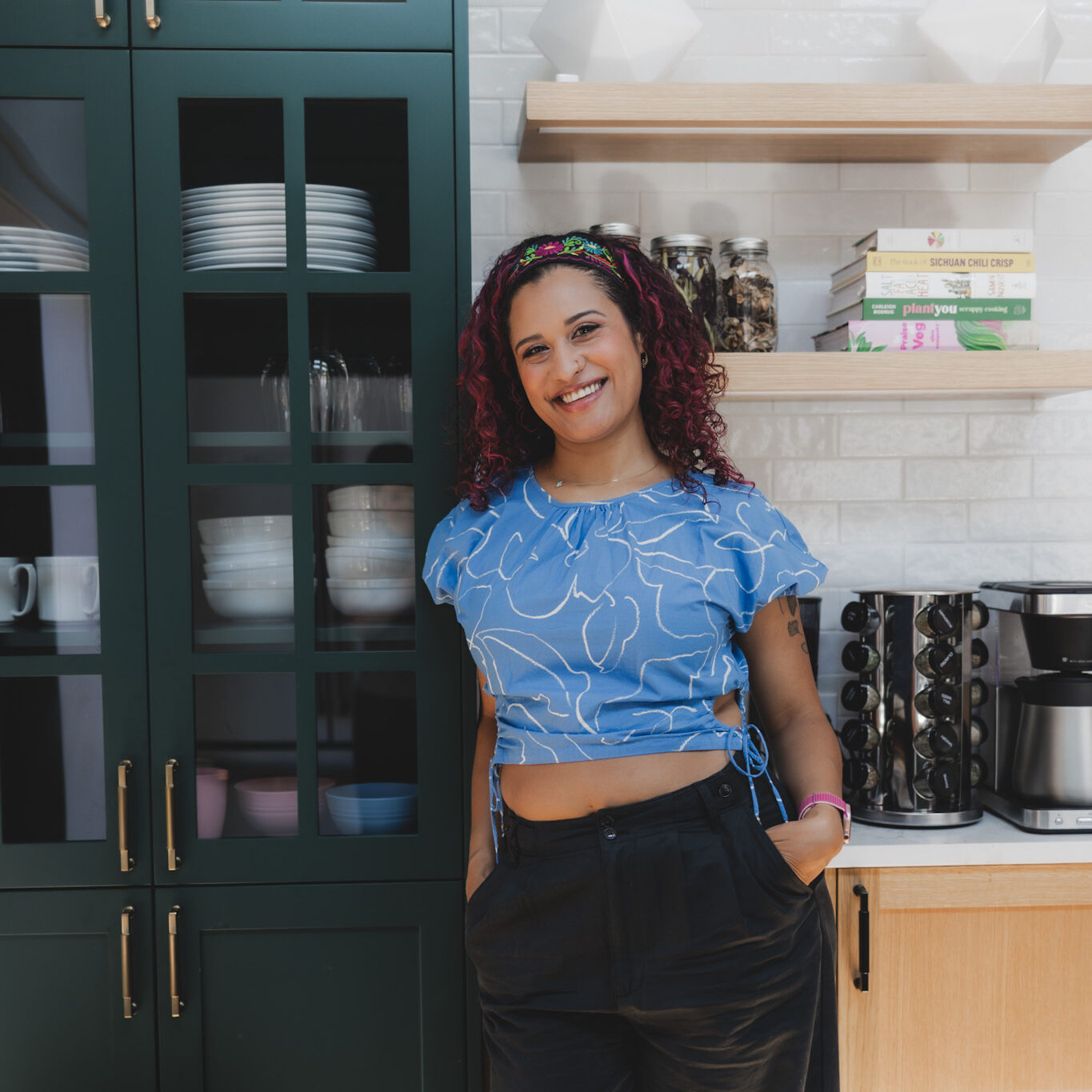 Photo of Taylor, owner of Kitchen Confetti posing in a modern kitchen